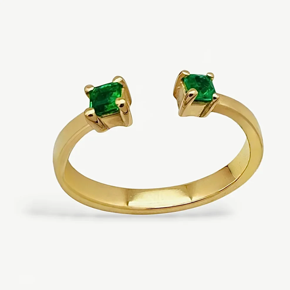 Anillo abierto en oro 18k con dos esmeraldas